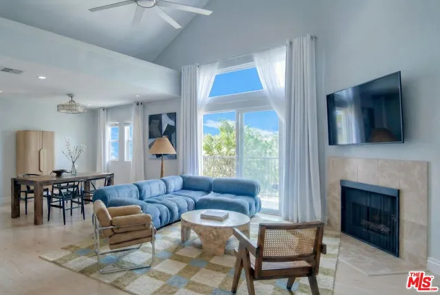 a view of an empty room with a fireplace and a window