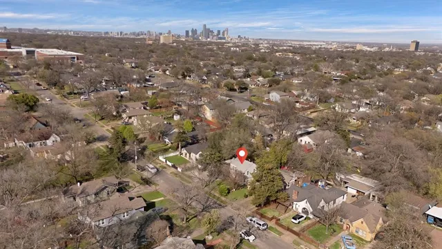 an aerial view of house with yard and mountain view in back