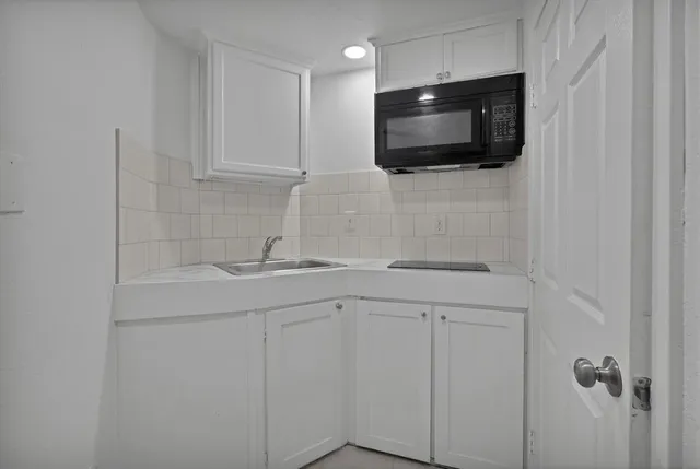 a kitchen with a sink and a microwave