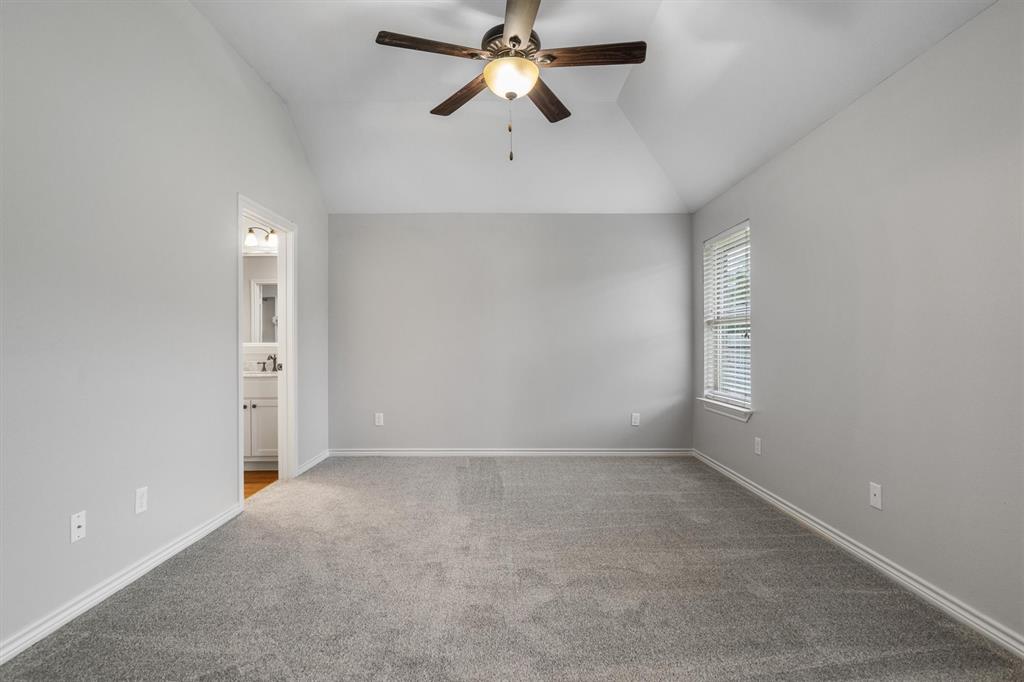 151 Birdsong Lane Terrell, TX 75160 - Photo 17 of 28 Spacious primary bedroom featuring newly replaced plush carpet, neutral tones, and plenty of room for large furniture.