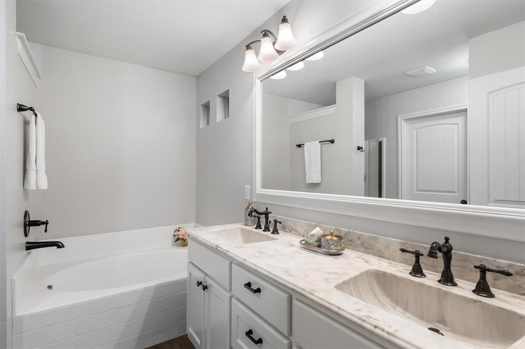 151 Birdsong Lane Terrell, TX 75160 - Photo 18 of 28 Primary bathroom with dual sinks, extended vanity, and bright lighting for everyday convenience.