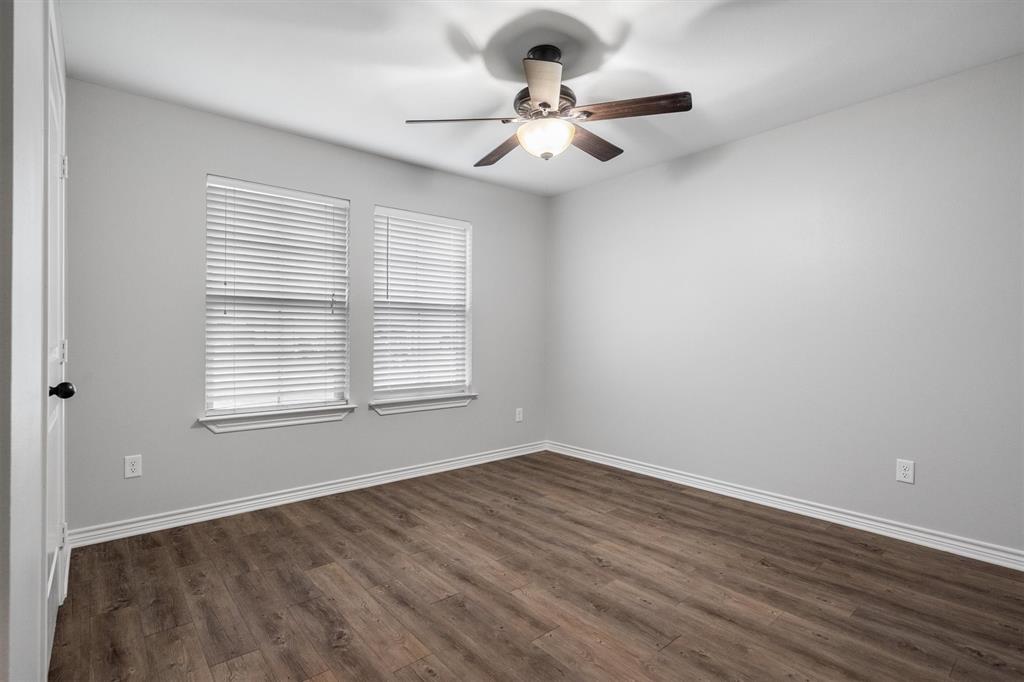 151 Birdsong Lane Terrell, TX 75160 - Photo 20 of 28 Comfortable bedroom with wood-style flooring, ceiling fan, and natural light from multiple windows.