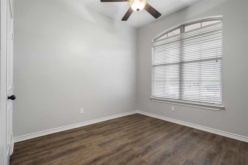 151 Birdsong Lane Terrell, TX 75160 - Photo 21 of 28 Additional bedroom featuring wood-style flooring, ceiling fan, and a large window for natural light.