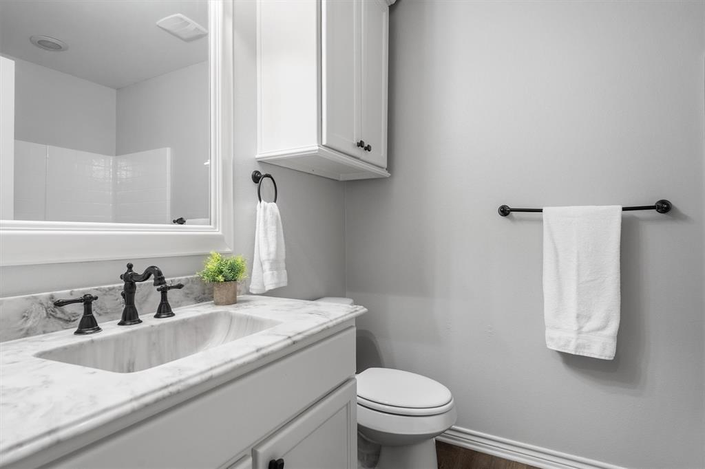 151 Birdsong Lane Terrell, TX 75160 - Photo 22 of 28 Full secondary bathroom with a clean design, vanity storage, and a tub-shower combination.