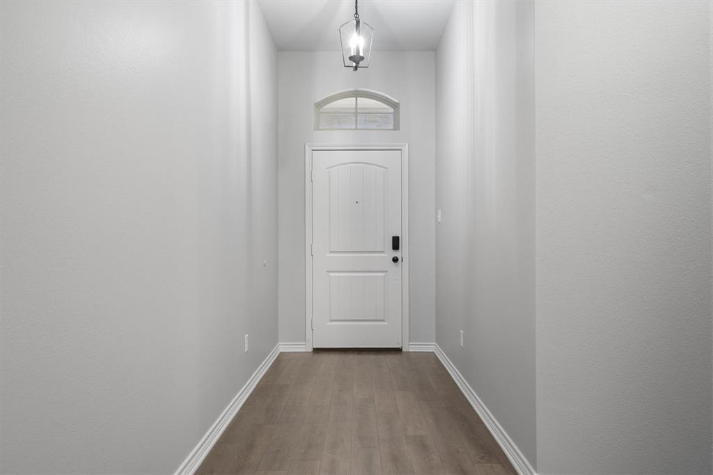 151 Birdsong Lane Terrell, TX 75160 - Photo 6 of 28 Bright entry hallway with tall ceilings and neutral tones, offering a welcoming introduction to the home.