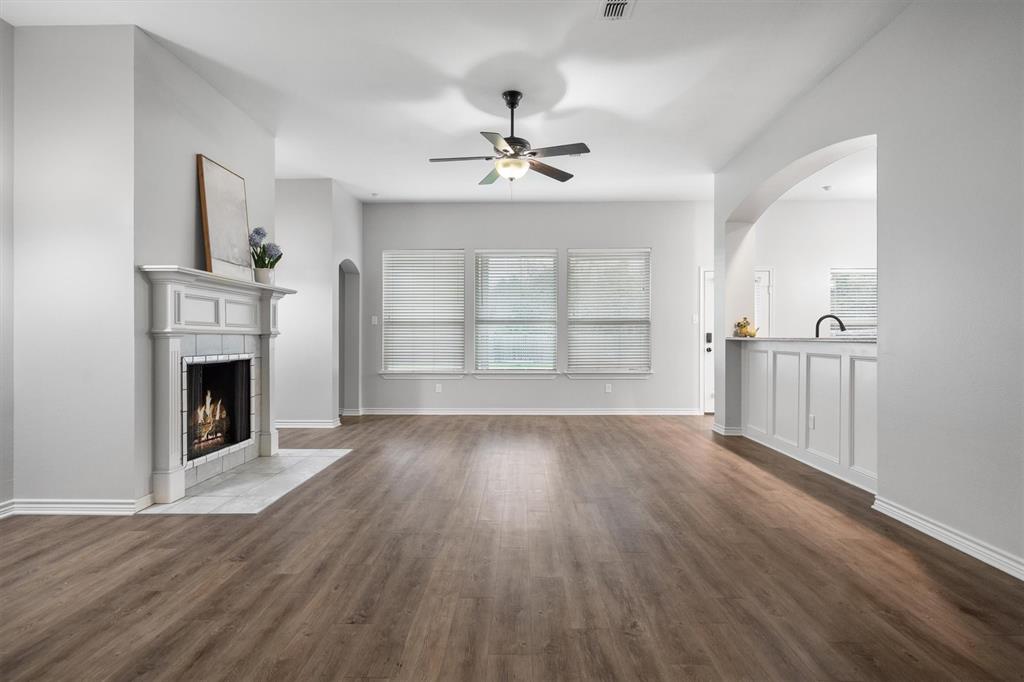 151 Birdsong Lane Terrell, TX 75160 - Photo 10 of 28 Expansive living space with wood flooring and large windows that bring in natural light throughout the room.