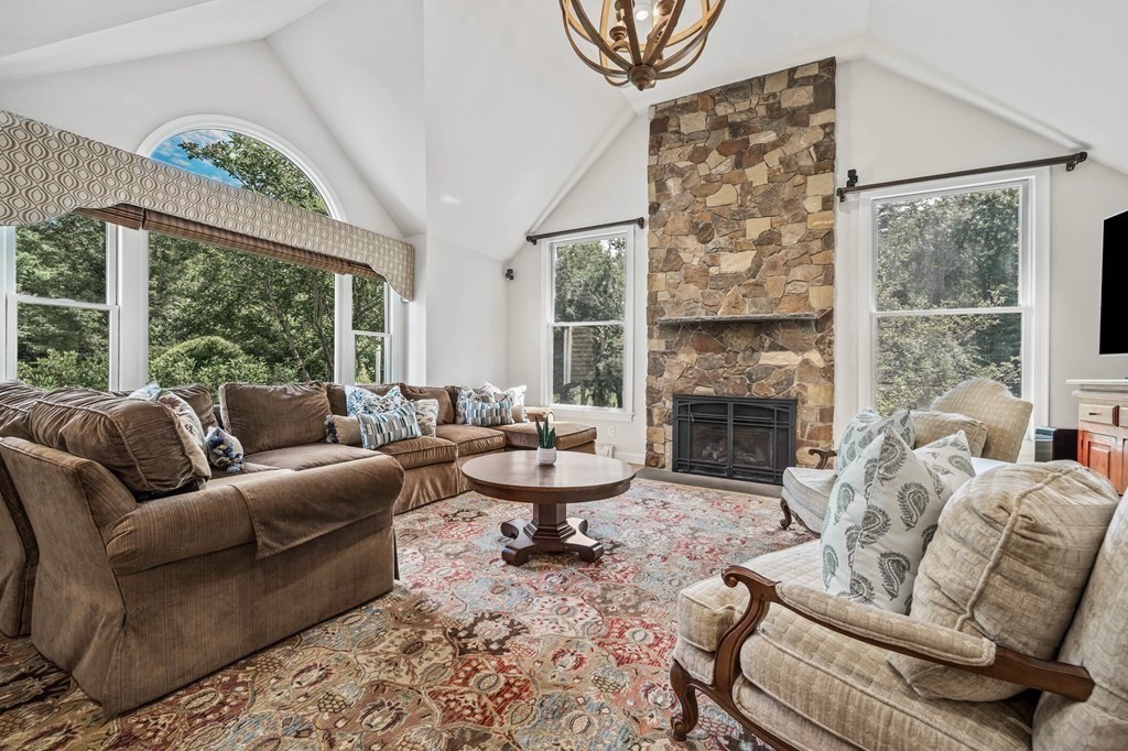 171 River Road Hanover, MA 02339 - Photo 11 of 39 a living room with furniture a fireplace and a large window