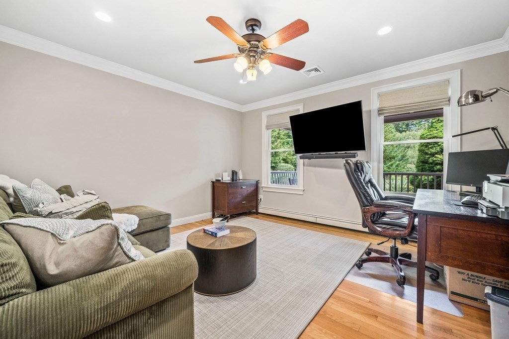 171 River Road Hanover, MA 02339 - Photo 13 of 39 a living room with furniture a flat screen tv and a large window