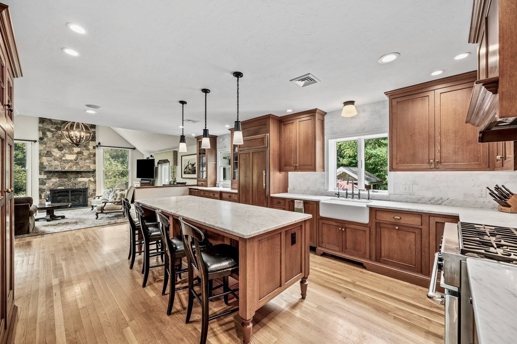 171 River Road Hanover, MA 02339 - Photo 7 of 39 a kitchen with stainless steel appliances granite countertop a kitchen island a stove a table and chairs in it