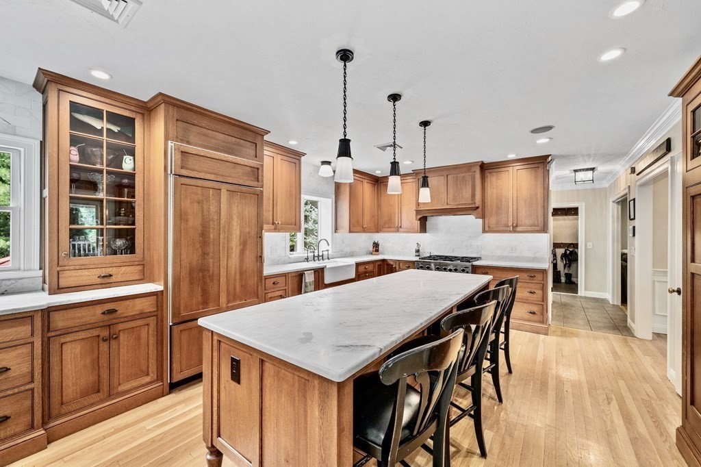 171 River Road Hanover, MA 02339 - Photo 8 of 39 a kitchen with a table chairs refrigerator and cabinets