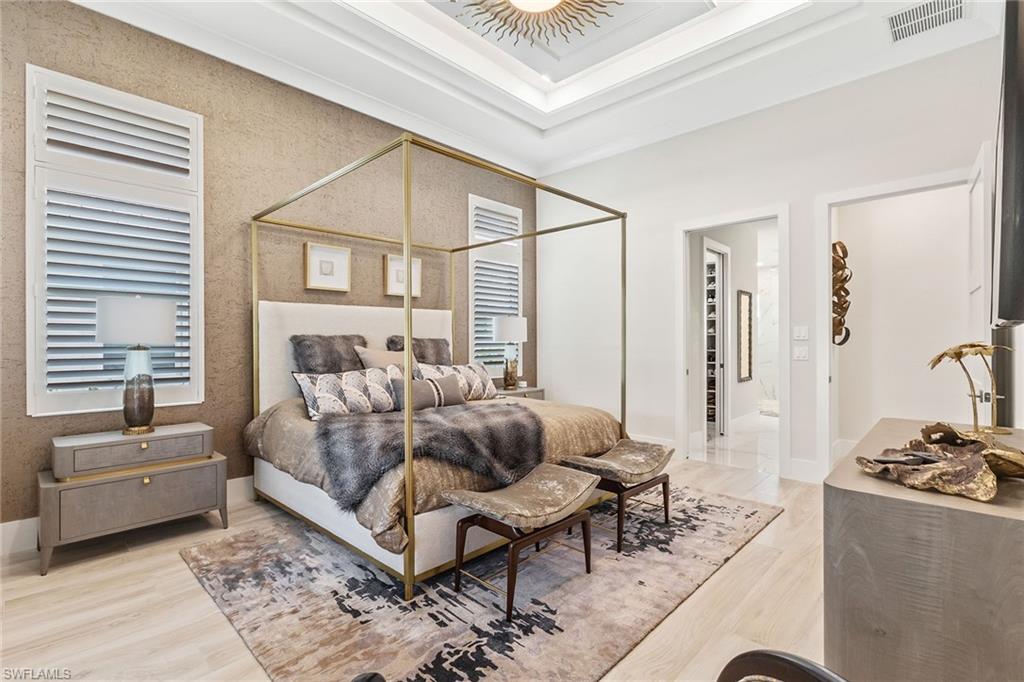 8829 Paradera Court Naples, FL 34112 - Photo 10 of 31 a bedroom with a bed and a couch