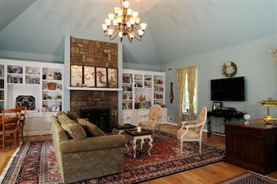 590 New Bedford Road Rochester, MA 02770 - Photo 11 of 20 a living room with furniture a flat screen tv and a fireplace