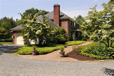590 New Bedford Road Rochester, MA 02770 - Photo 2 of 20 a front view of a house with a yard and garage