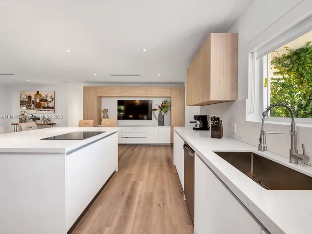 a living room with furniture large window and a chandelier