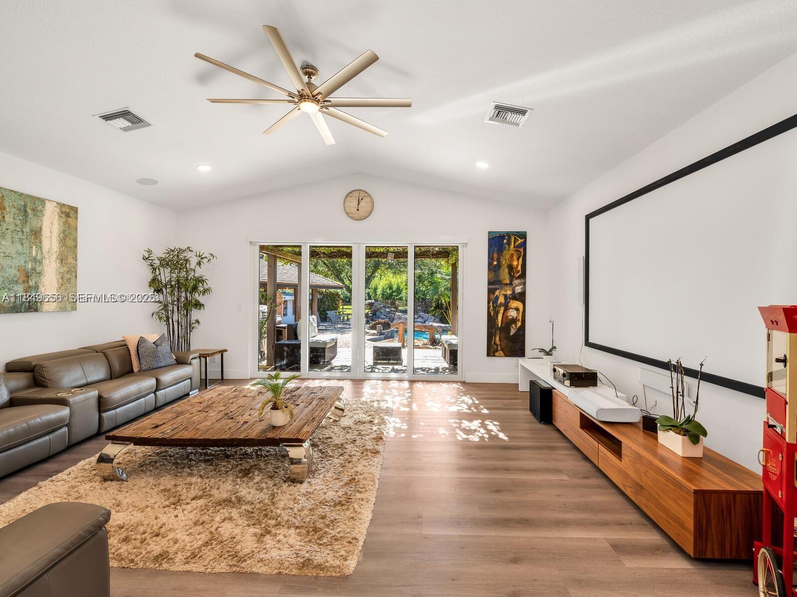 13350 Luray Road Southwest Ranches, FL 33330 - Photo 13 of 56 a living room with furniture large window and a chandelier