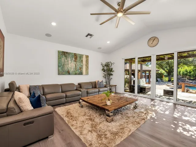 a view of living room with a floor to ceiling window and wooden floor