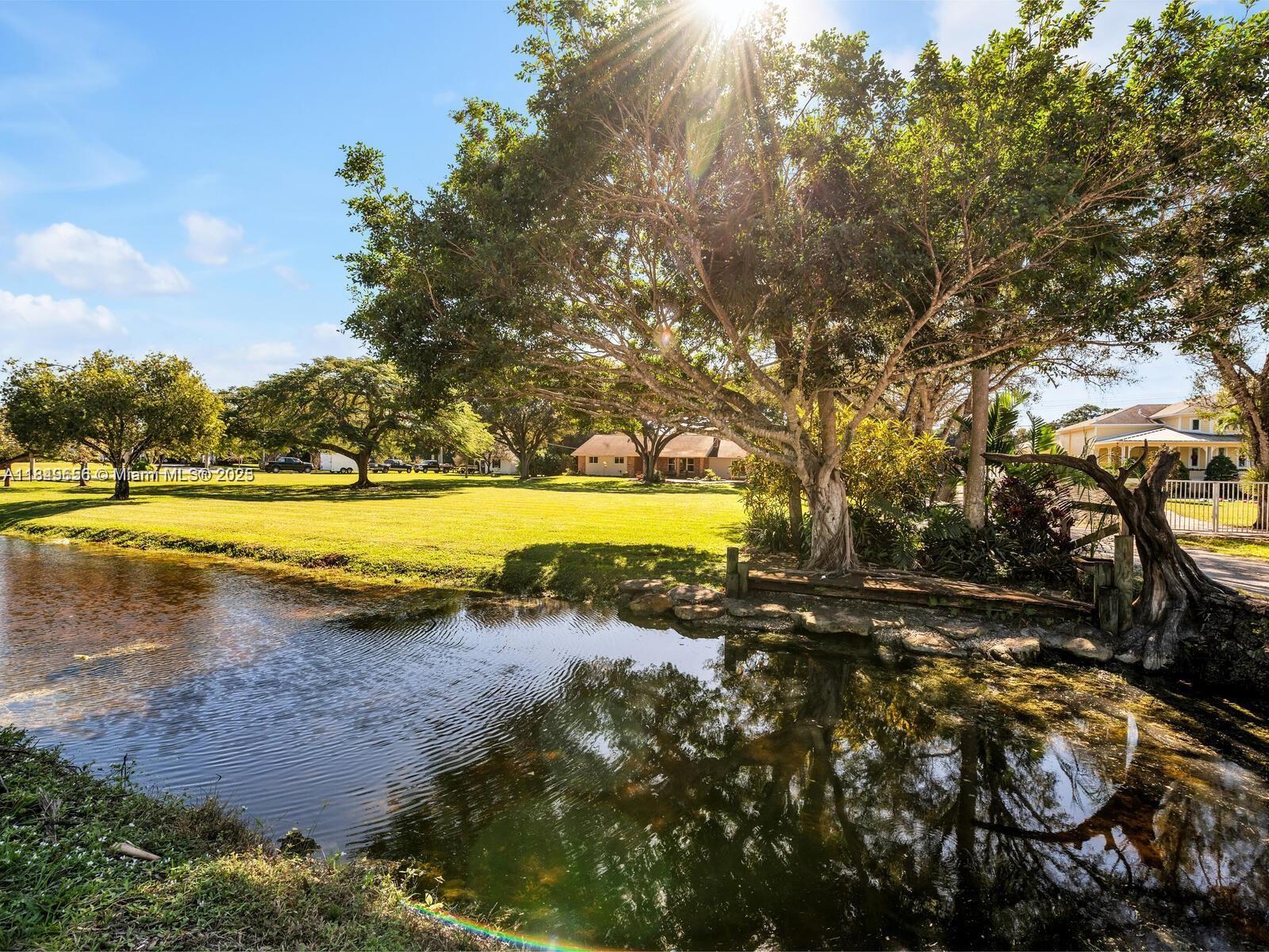13350 Luray Road Southwest Ranches, FL 33330 - Photo 2 of 56 a view of a lake with houses in the back