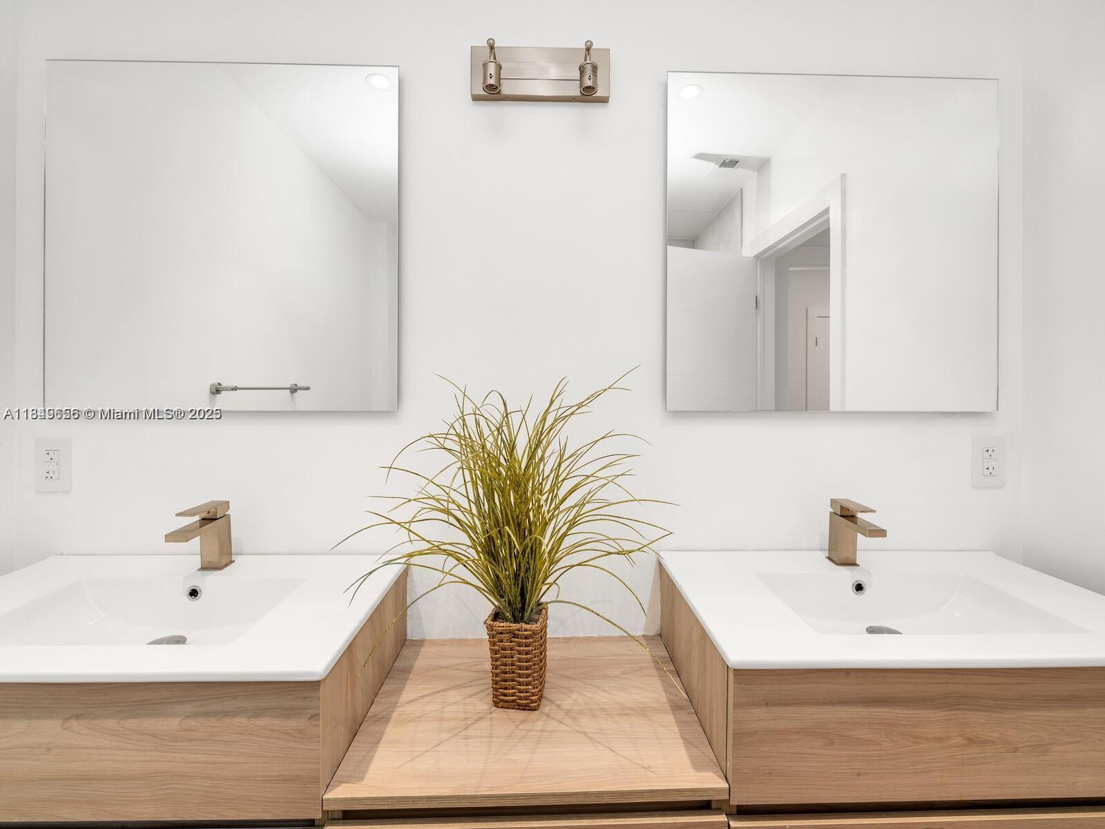 13350 Luray Road Southwest Ranches, FL 33330 - Photo 23 of 56 a bathroom with a sink a mirror and a shower