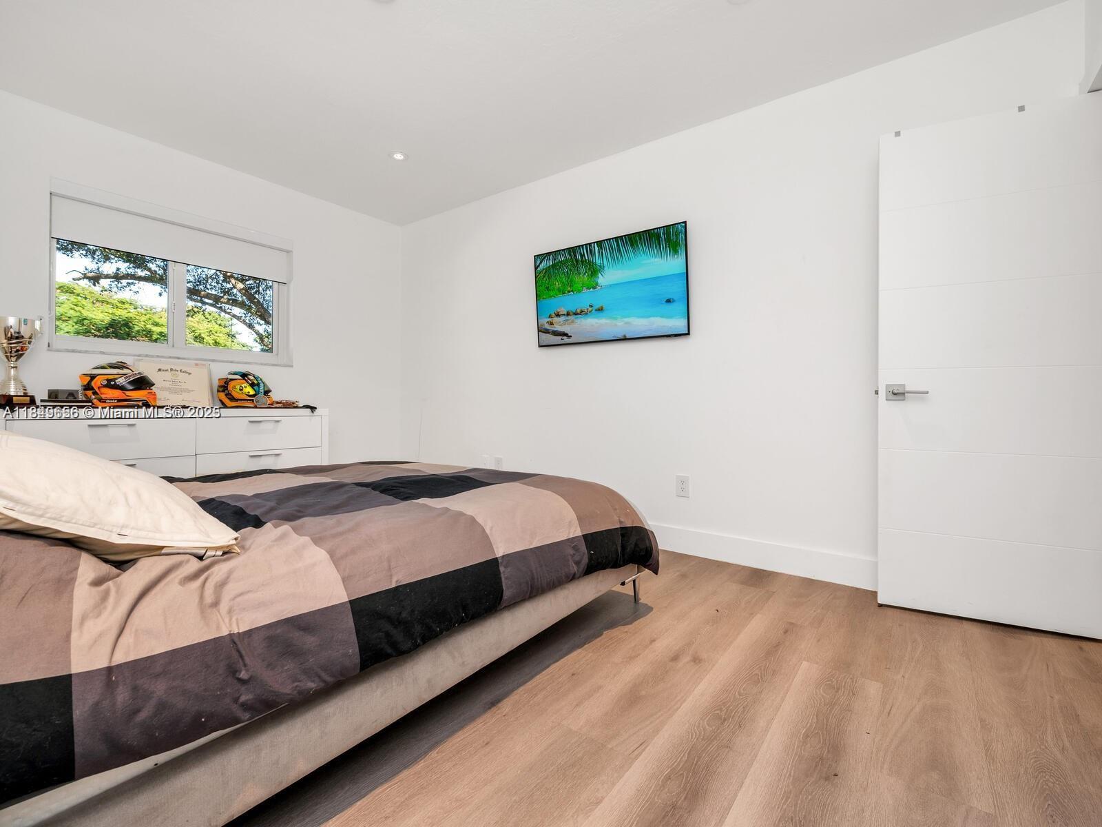 13350 Luray Road Southwest Ranches, FL 33330 - Photo 24 of 56 a bedroom with a bed and a window