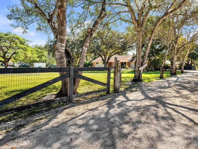 a view of a backyard with swimming pool
