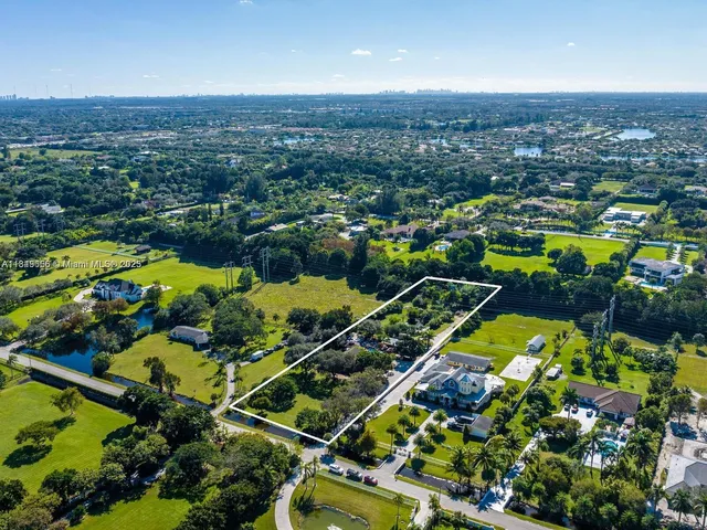 an aerial view of a houses with a lake view