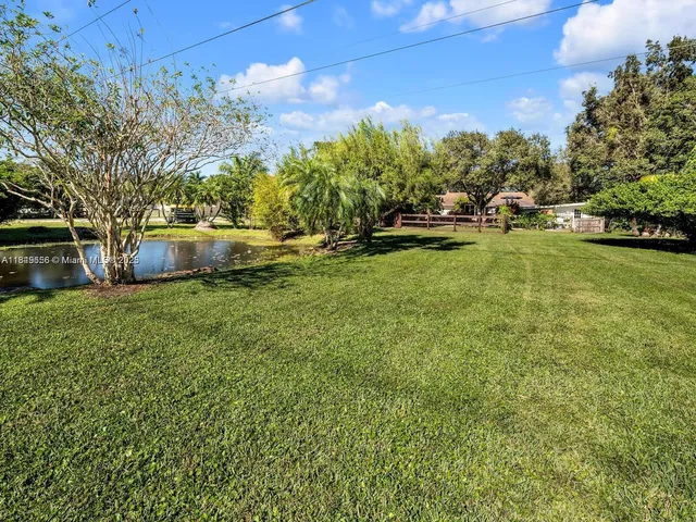 an aerial view of a houses with a yard