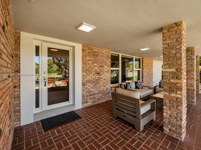 a view of a patio with table and chairs with wooden floor and fence