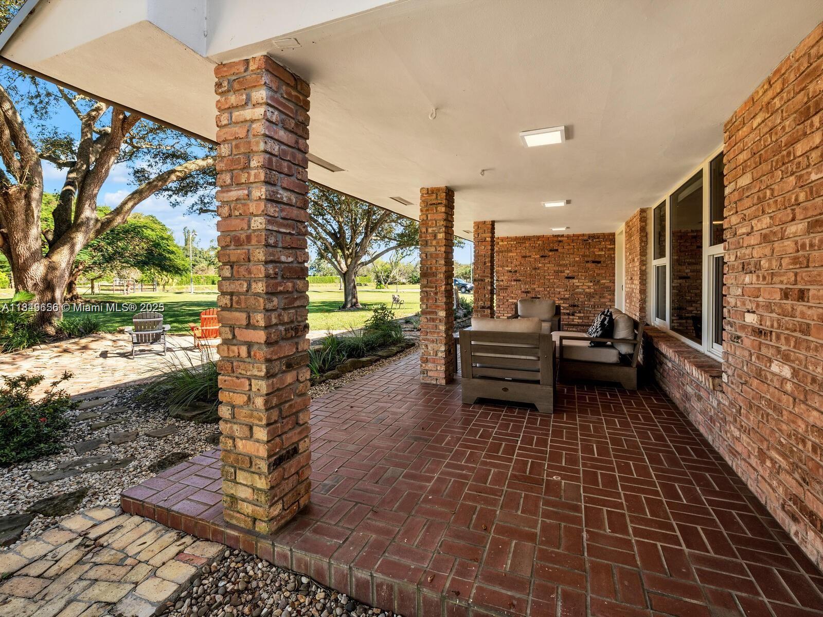 13350 Luray Road Southwest Ranches, FL 33330 - Photo 6 of 56 a view of a patio with table and chairs with wooden floor and fence