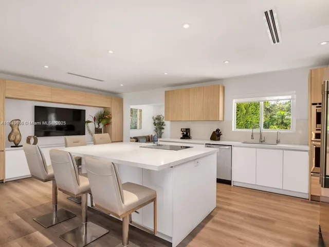a large kitchen with a sink and cabinets