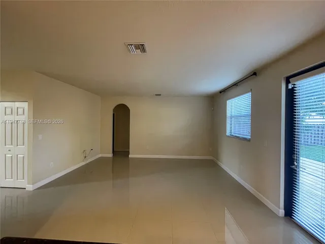 an empty room with a empty space and a ceiling fan