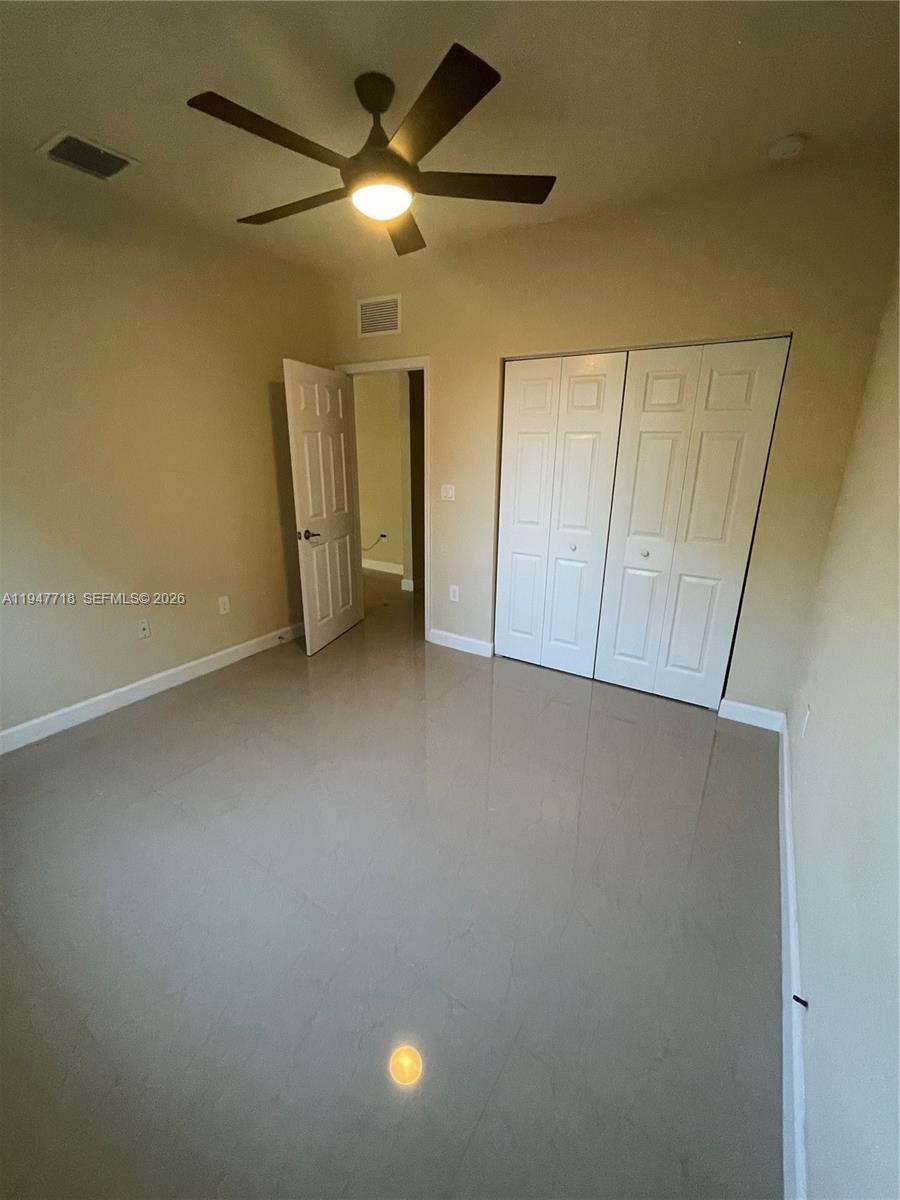10417 Southwest 231st Terrace Miami, FL 33190 - Photo 22 of 60 an empty room with a empty space and a ceiling fan