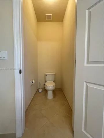 a front view of a house with a yard and fence