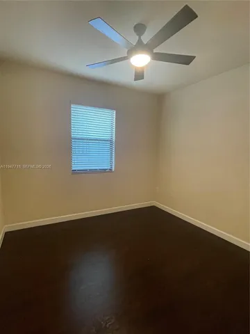 a view of a house with a yard and fence