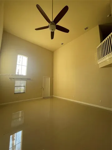 a large kitchen with stainless steel appliances a large counter top a stove and a refrigerator