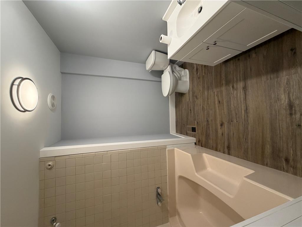 19 Springridge Road Bath, PA 18014 - Photo 16 of 29 Smooth walls and classic tiling pair with warm wood-look flooring in this functional bathroom.