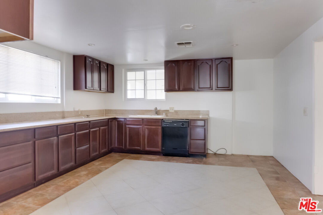 4336 Alla Road Los Angeles, CA 90066 - Photo 11 of 54 a kitchen with stainless steel appliances granite countertop a sink and a stove with wooden cabinet