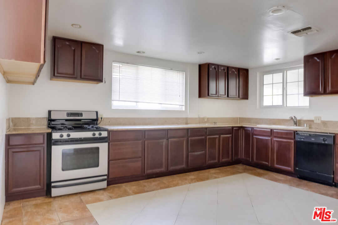 4336 Alla Road Los Angeles, CA 90066 - Photo 12 of 54 a kitchen with granite countertop a sink stainless steel appliances and cabinets