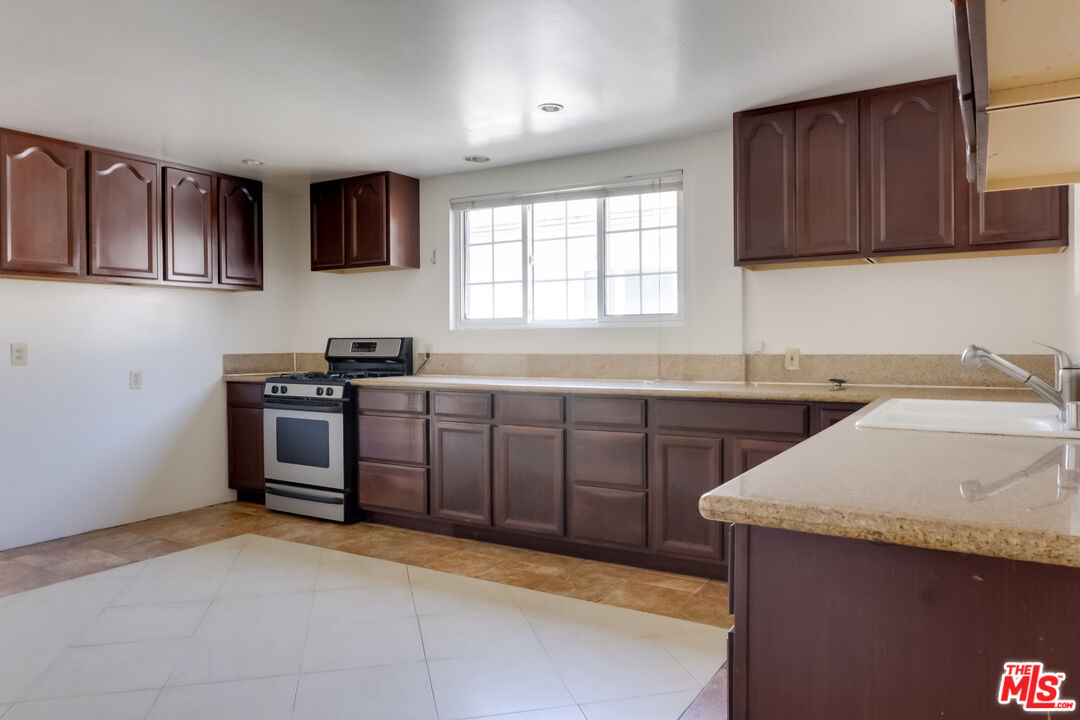 4336 Alla Road Los Angeles, CA 90066 - Photo 13 of 54 a kitchen with a sink a stove and cabinets