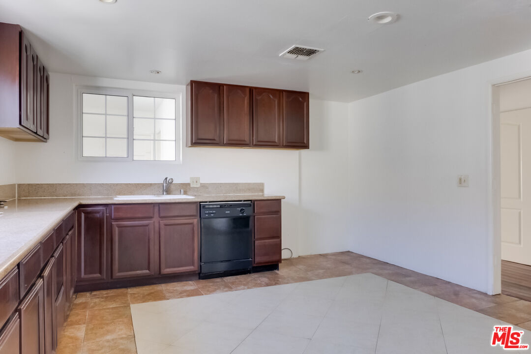 4336 Alla Road Los Angeles, CA 90066 - Photo 15 of 54 a kitchen with stainless steel appliances granite countertop a sink and a stove top oven with granite countertops