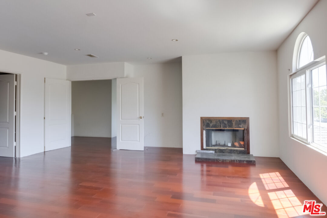 4336 Alla Road Los Angeles, CA 90066 - Photo 18 of 54 an empty room with wooden floor fire place and windows
