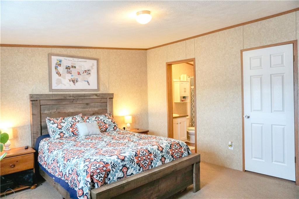 218 Rustic Ridge Lane Butler, PA 16002 - Photo 12 of 19 a bedroom with a bed and painting on the wall