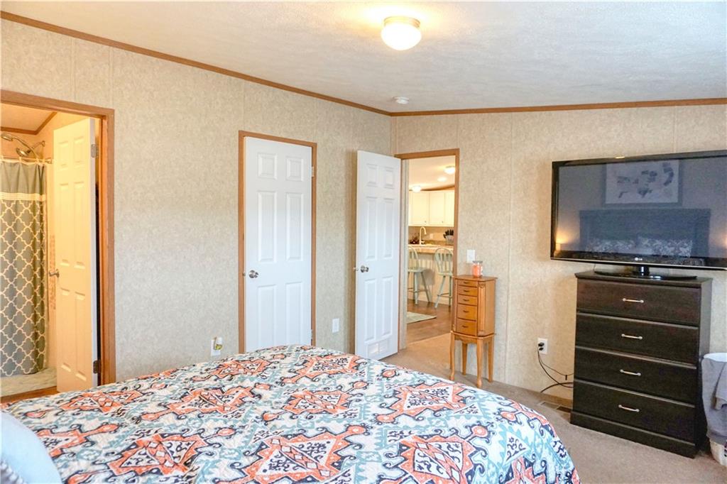 218 Rustic Ridge Lane Butler, PA 16002 - Photo 13 of 19 a bedroom with a bed and a dresser