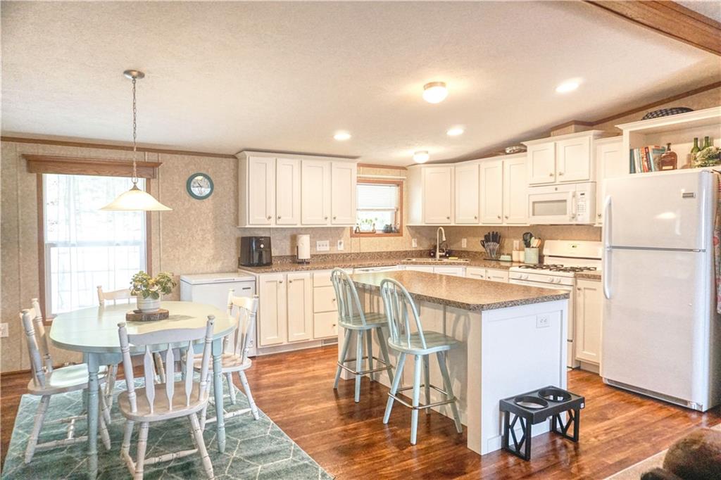218 Rustic Ridge Lane Butler, PA 16002 - Photo 7 of 19 a kitchen with stainless steel appliances granite countertop a table chairs refrigerator and a sink