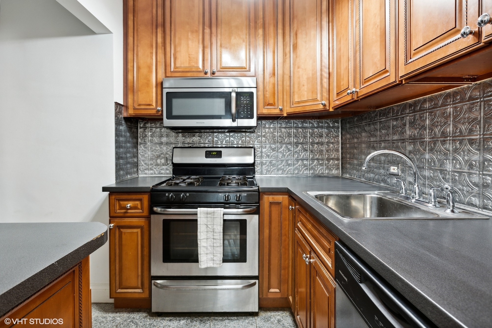 6101 North Sheridan Road, Unit 9D Chicago, IL 60660 - Photo 11 of 22 a kitchen with stainless steel appliances granite countertop a stove and a microwave