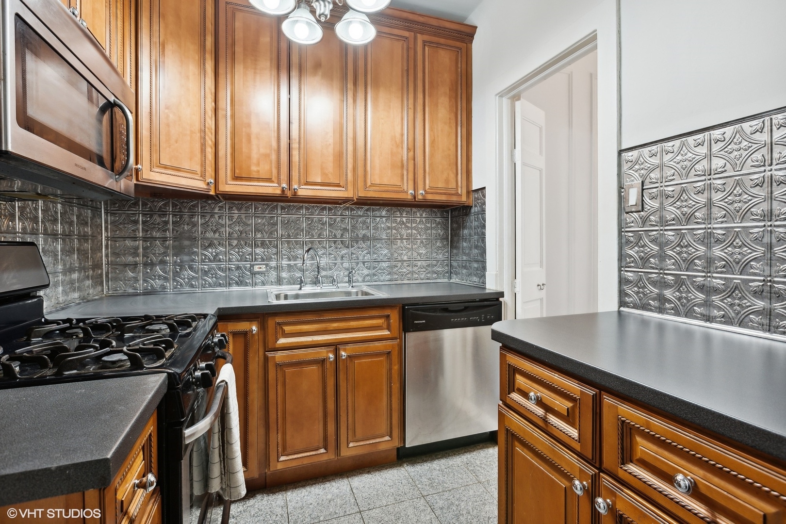 6101 North Sheridan Road, Unit 9D Chicago, IL 60660 - Photo 12 of 22 a kitchen with stainless steel appliances granite countertop a sink stove and cabinets