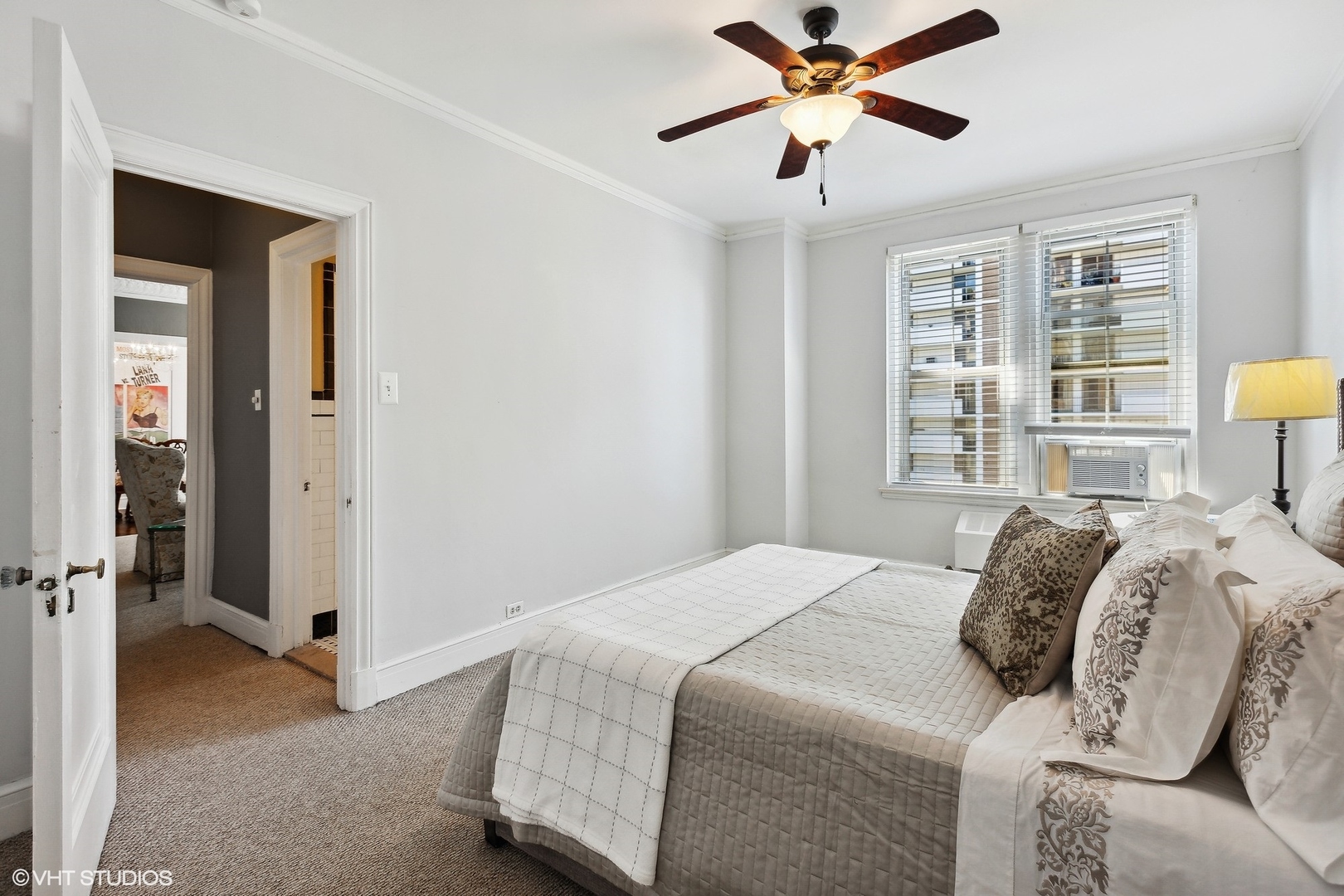 6101 North Sheridan Road, Unit 9D Chicago, IL 60660 - Photo 16 of 22 a bedroom with a bed and a chandelier