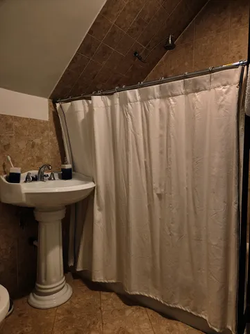 a bathroom with a sink a mirror and a shower