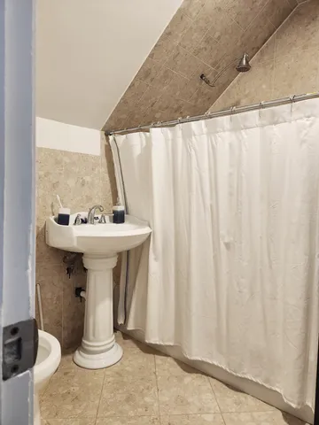 a bedroom with a bed and painting on the wall