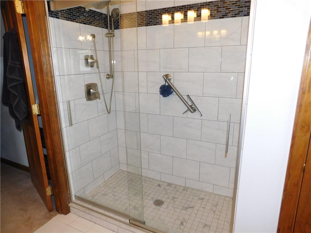 105 Spohn Road Freeport, PA 16229 - Photo 14 of 25 Artisan tile work in the newly designed master bath en suite with sleek contemporary Moen brushed nickel fixtures, striking black granite vanity top, swooped sink is just luxurious.
