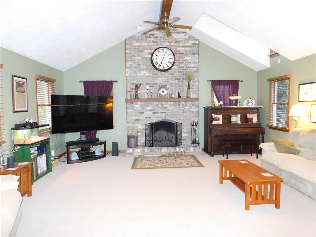 105 Spohn Road Freeport, PA 16229 - Photo 5 of 25 Dramatic brick, log burning fireplace with soaring, beamed cathedral ceiling & 2 paddle fans